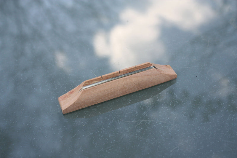 Cherrywood fretwire saddle/ string spacer for 3 string cigar box guitar.