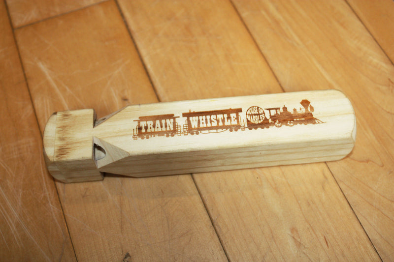 Wooden train whistle made by House of Marbles.
