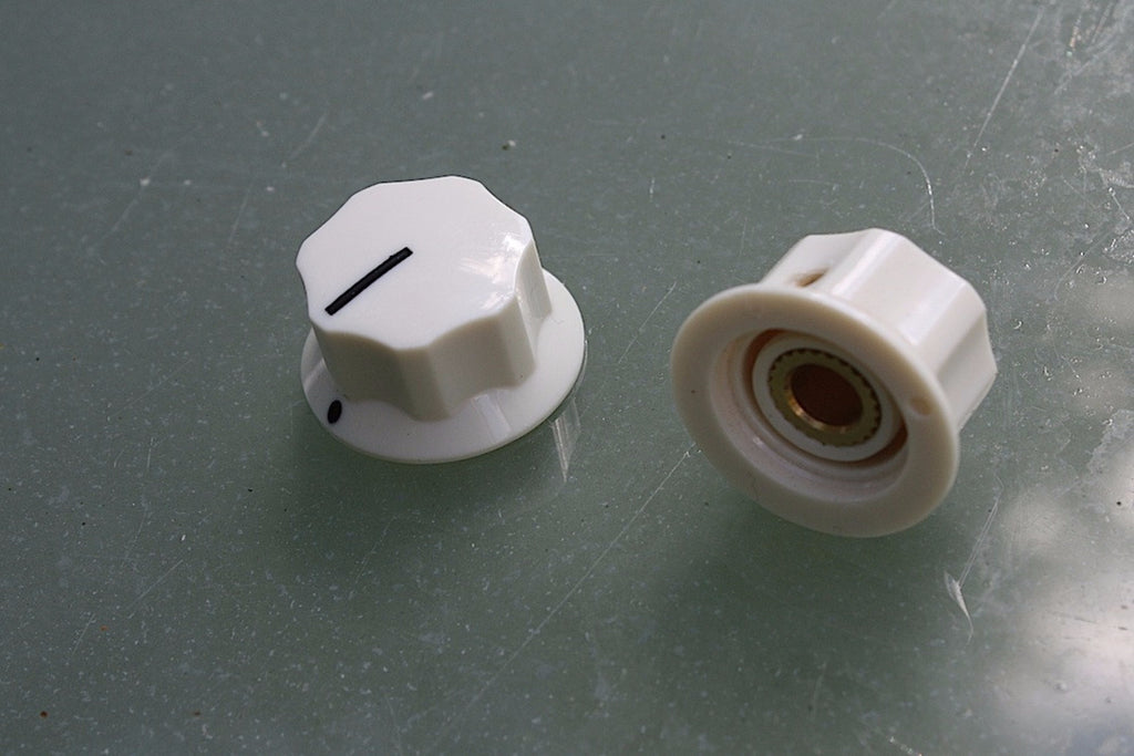 Radio-style control knobs in cream, pair.