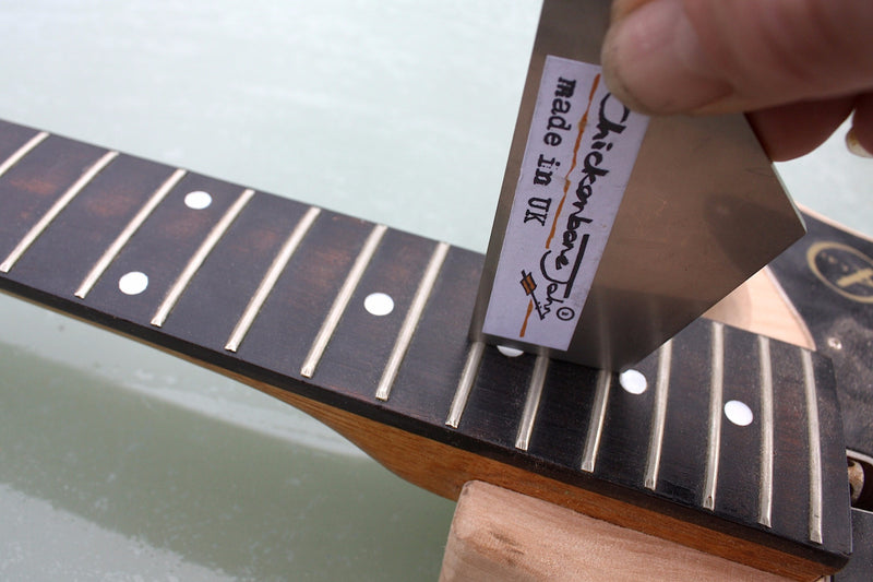 Stainless steel fret rocker to level out guitar frets. 