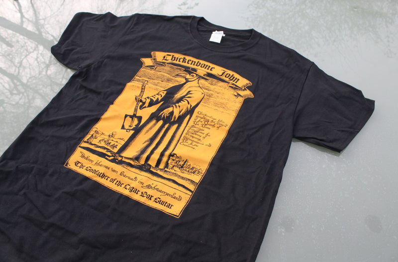 ChickenboneJohn T-Shirt with Plague Doctor design. AMber on black, with small logo on the back. 100% cotton.