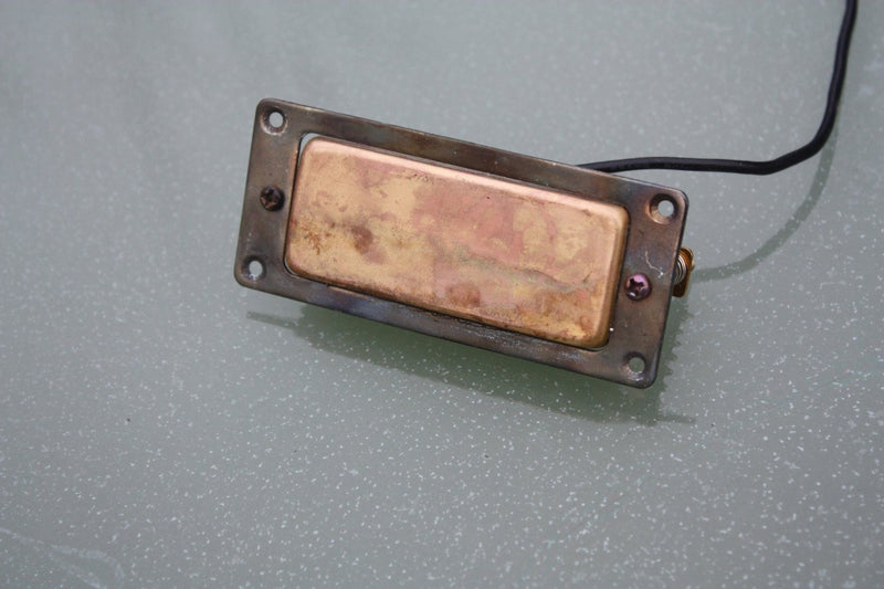 Mini Humbucker pickup aged brass with mounting ring. Fixing screws included.