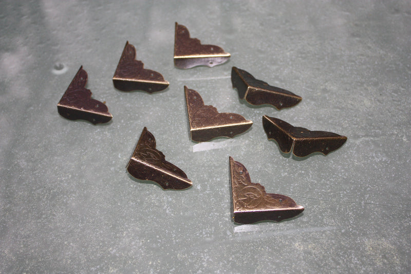 Medium antiqued bronze corner protectors with embossed phoenix design, fixing nails included.
